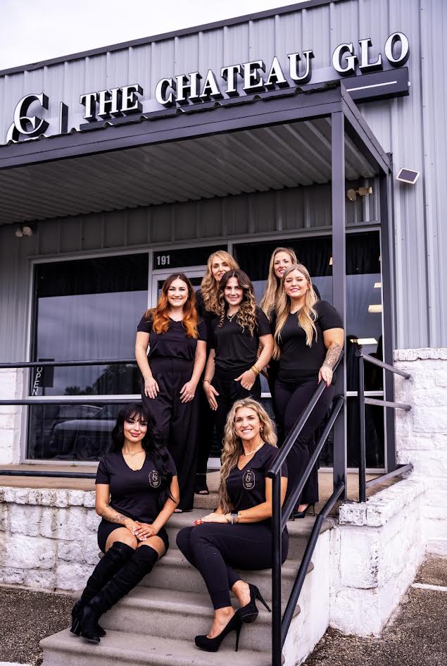 The Chateau Glo team posed on the front staircase outside the beauty lounge